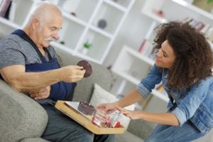 Caregiver preparing meal for patient