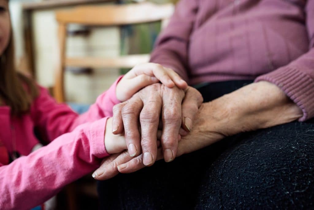 Two people holding hands