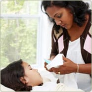 nurse taking care patient in bed