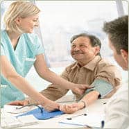 nurse checking patients's blood pressure