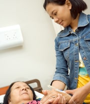 patient laying down with caregiver