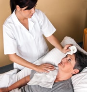 nurse taking care patient in bed