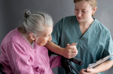 patient with knee brace and a physical therapist