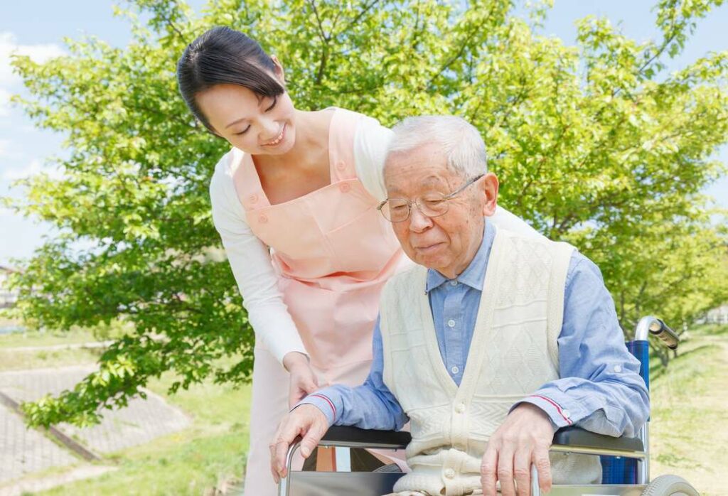 Nurse helping patient on wheelchair